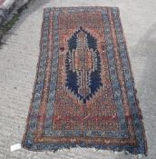 A Persian rug, the central medallion on a red ground with a red and blue stepped border approx.