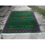 A Gabbeh carpet, the central ground green with red and blue border approx.