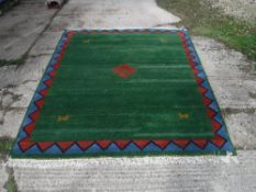 A Gabbeh carpet, the central ground green with red and blue border approx.