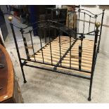 A pair of modern black painted wrought iron single bedsteads in the Victorian style,