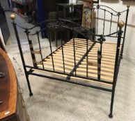 A pair of modern black painted wrought iron single bedsteads in the Victorian style,