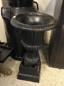 A black painted milk churn, approx 67 cm high, a black painted cast iron urn,