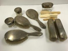 A silver mounted dressing table set comprising a pair of brushes, a pair of clothes brushes,