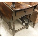 A 19th Century oak oval gate-leg drop-leaf dining table in the 17th Century manner,