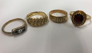 A collection of 18 carat gold dress rings, one set with diamond to centre,