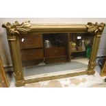 A late Victorian giltwood and gesso framed overmantel mirror with column and foliate decoration,