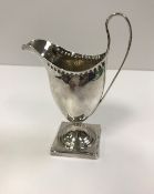 A George III silver cream jug of inverted helmet form (by Peter and Anne Bateman, London 1793),