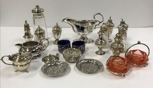 A box of assorted silver and plated items to include various silver baluster shaped peppers,