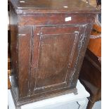 An 18th Century oak dwarf cupboard, the single door enclosing three shelves,