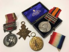 A collection of medals comprising a Victorian South Africa medal with bars for Transvaal,