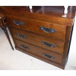 A Lombok teak chest of three drawers with iron handles raised on a plinth base,