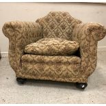 A pair of early 20th Century floral upholstered deep seated scroll armchairs on squat bun front