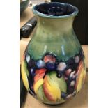 A William Moorcroft baluster shaped vase, leaf and berry pattern,