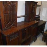 An Edwardian mahogany and blind fretwork decorated side cabinet with two glazed cabinets linked by