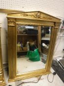 A pair of modern Empire style gilt framed wall mirrors of arched architectural form,