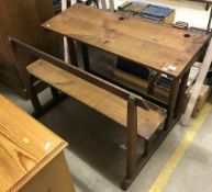 A 19th Century French fruitwood double school desk with integral bench seat 110 cm wide x 78 cm