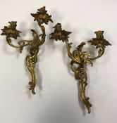 A pair of 19th Century gilt bronze wall sconces of scrolling acanthus form in the Louis XV taste,