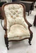 A Victorian mahogany framed button back show frame salon chair with scroll arms on turned and