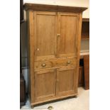 An early 20th Century pine kitchen cupboard with two doors over a single drawer and two further