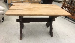 A Victorian pine kitchen table, the rectangular plank top with rounded corners,