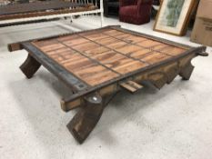 An Indian teak and iron bound camel sledge table of typical form,