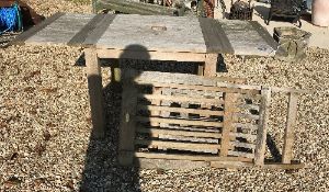 A modern teak slatted steamer chair and slatted garden table