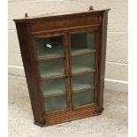 A 19th Century mahogany glazed and barred two door hanging corner cabinet with painted three shelf