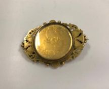 A George IV 1826 gold plated sixpence, housed in a yellow metal pierced frame as a brooch,