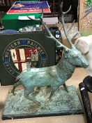 A 20th Century verdigris patinated bronze study of a 12 pointer stag on a white-veined black marble