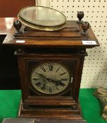 A 19th Century German walnut cased eight day mantel clock with silvered dial and Roman numerals,