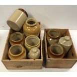 Two wooden wine crates containing various stoneware storage jars,