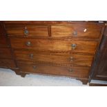 A Regency mahogany and rosewood strung chest of two short over three long graduated drawers on