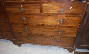 A Regency mahogany and rosewood strung chest of two short over three long graduated drawers on