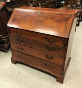 A late George III mahogany and inlaid bureau,