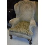 A circa 1900 wing back scroll arm chair in the early Georgian manner,