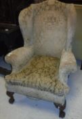 A circa 1900 wing back scroll arm chair in the early Georgian manner,