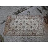 A Ziegler designed rug, the central panel set with all over foliate design on a cream ground approx.