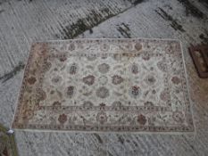 A Ziegler designed rug, the central panel set with all over foliate design on a cream ground approx.