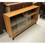 A set of three 20th Century ash sliding glazed door cabinets of plain form raised on ebonised