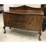 An early to mid 20th Century mahogany serpentine fronted sideboard in the Georgian style with three