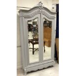 A French painted armoire in the Louis XV taste with two shaped bevel edged mirrored doors