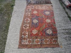 A Caucasian carpet section of red, blue and yellow colour approx.