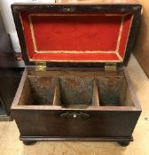 A George III mahogany sarcophagus shaped tea caddy with brass swan neck handle raised on turned cup