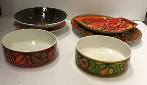 A collection of Poole pottery bowls, platters, etc.