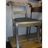 A pair of Continental embossed silver coloured metal covered bar back chairs with ram's head