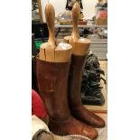 A pair of brown leather riding boots with wooden trees CONDITION REPORTS The size of