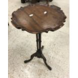 A reproduction mahogany cluster column wine table on tripod base,