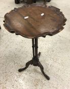 A reproduction mahogany cluster column wine table on tripod base,