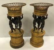 A pair of 19th Century French Regence bronze and gilt bronze jardiniers as three cherubs holding