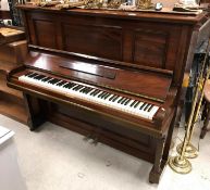 A rosewood cased upright piano, the iron